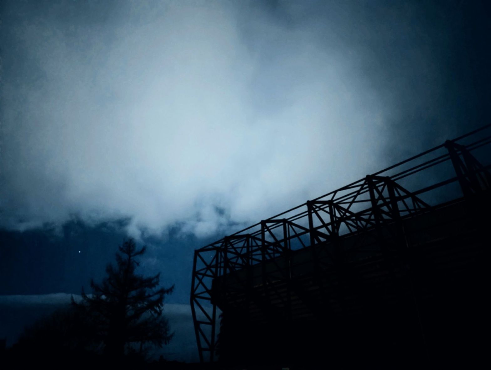 Floodlight structure silhouetted against a deep blue night sky, Kilmarnock